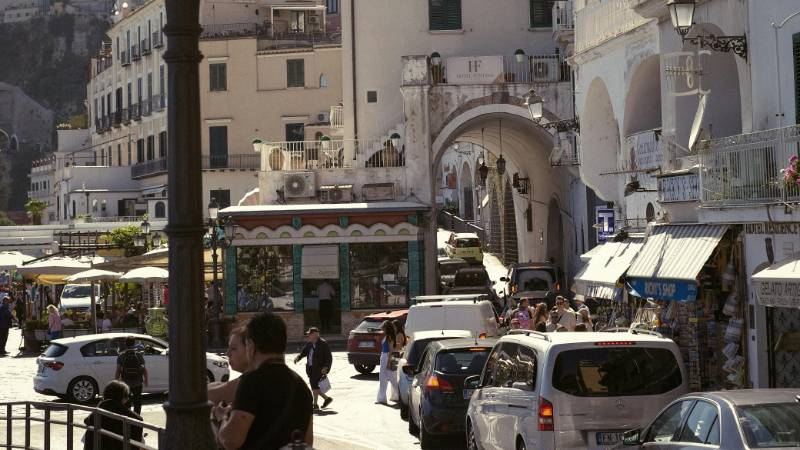 A charming town square in Amalfi with outdoor cafes and historic buildings