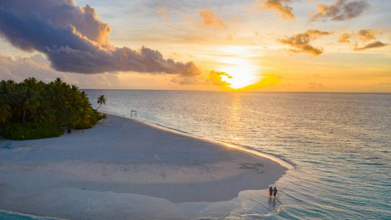 Couple enjoying a romantic sunset over the Bora Bora lagoon