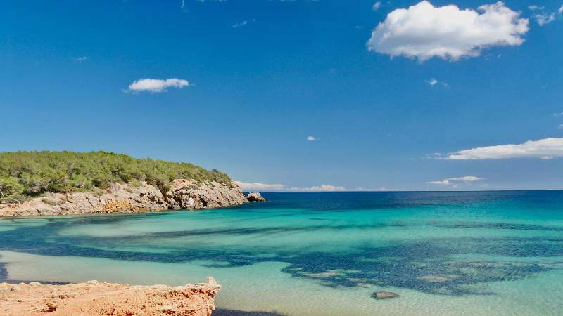 The stunning Cala Comte beach in Ibiza with turquoise waters and golden sand