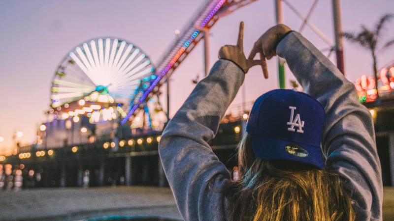 Santa Monica Pier at sunset with vibrant lights and ocean views