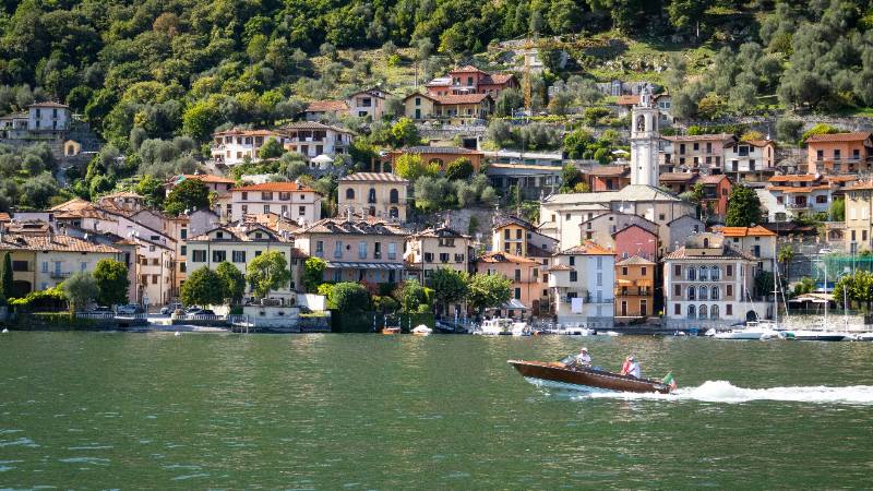 Enjoying a classic wooden boat ride on the serene waters of Lake Como