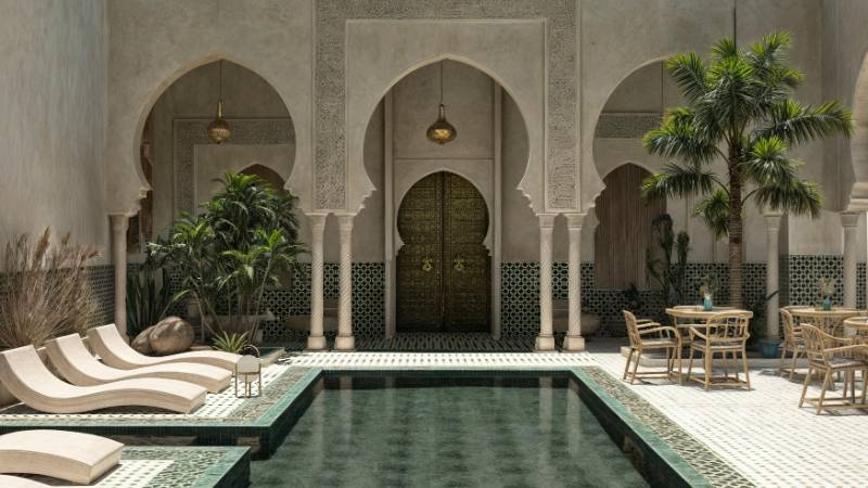 A serene and luxurious riad courtyard with a pool and traditional Moroccan design