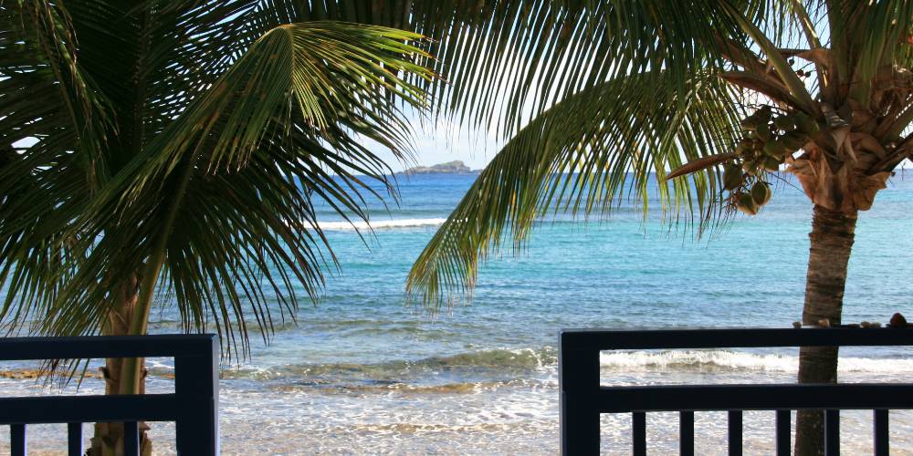 Pristine beach in St. Barts with turquoise water and a luxury villa